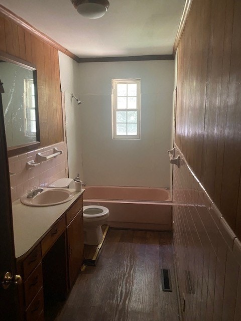 full bathroom with vanity, backsplash, crown molding, and wood-type flooring