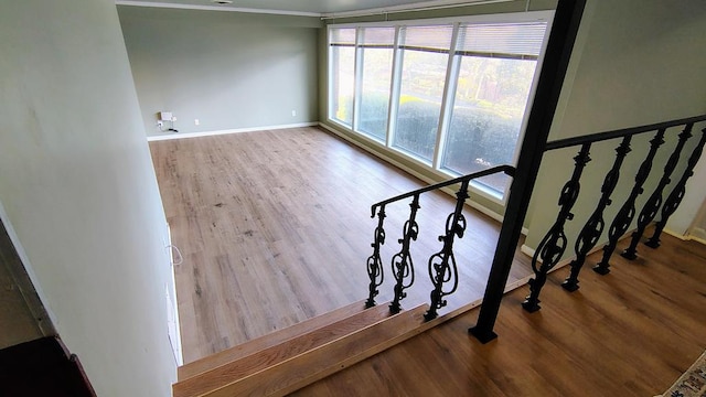 stairway featuring baseboards and wood finished floors