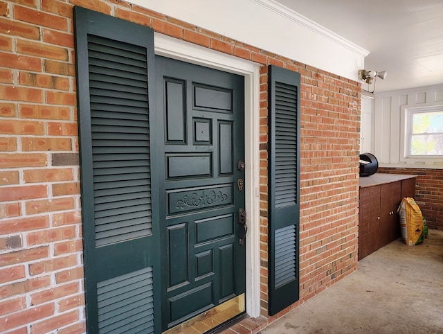 view of exterior entry with brick siding
