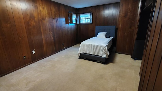 carpeted bedroom featuring wooden walls
