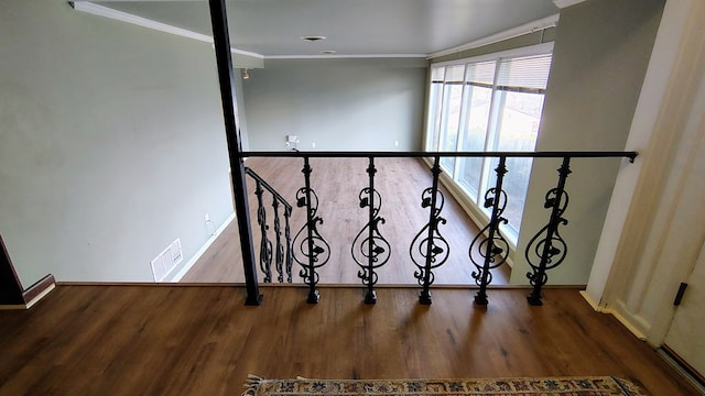 stairs with baseboards, visible vents, wood finished floors, and ornamental molding