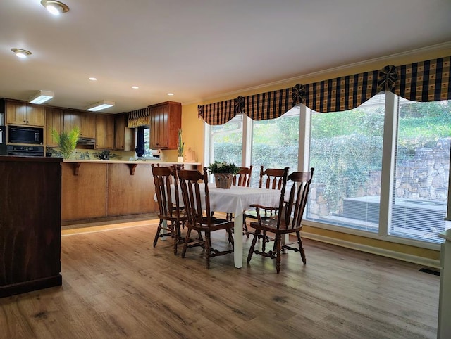 dining room with recessed lighting and wood finished floors