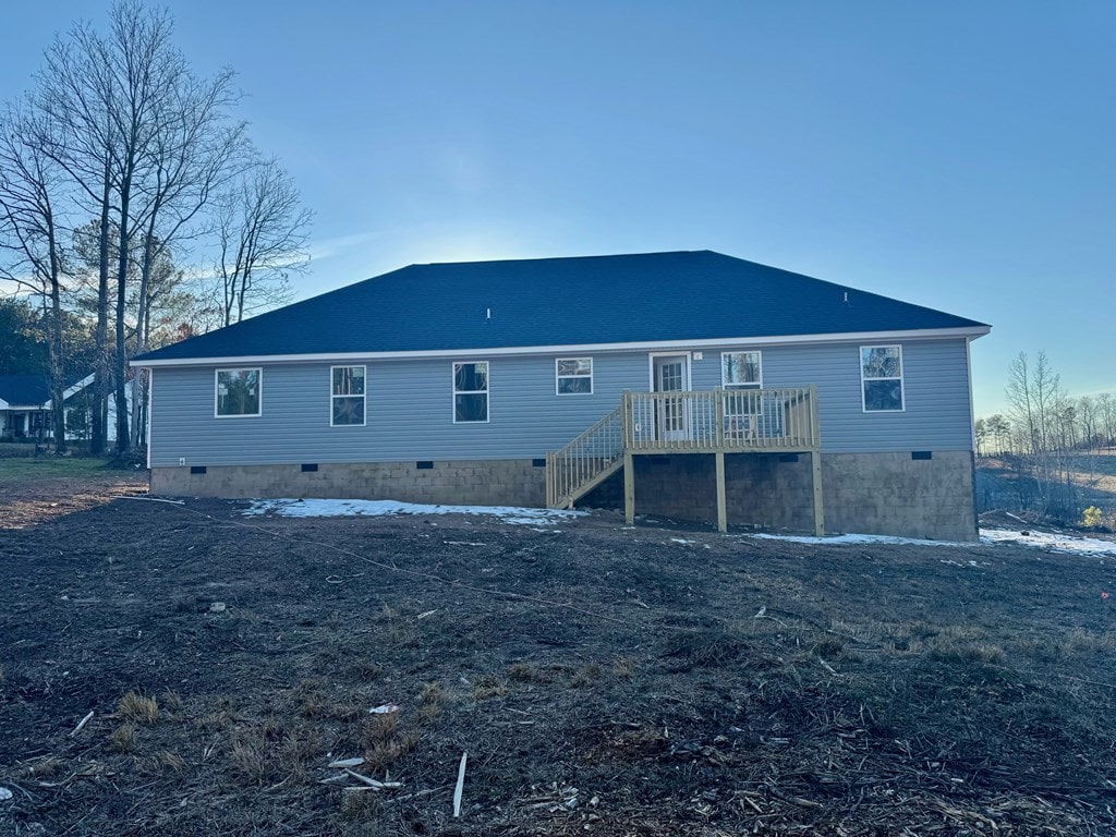 rear view of property featuring a wooden deck