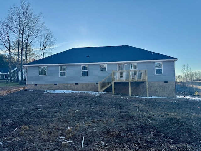 rear view of property featuring a wooden deck