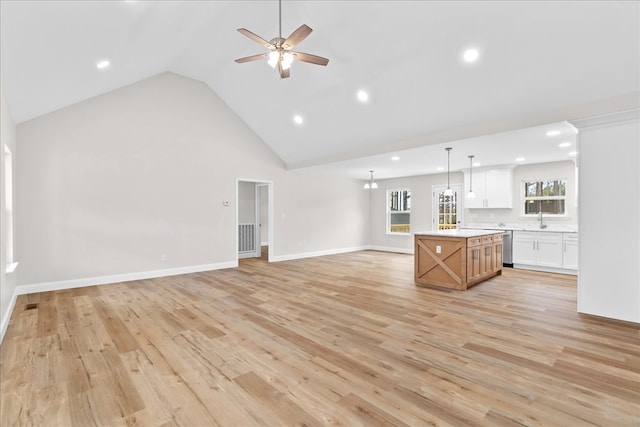 288 Flag Way, Chatsworth, GA 30705 - unfurnished living room with high vaulted ceiling, baseboards, a sink, light wood-style floors, and a ceiling fan