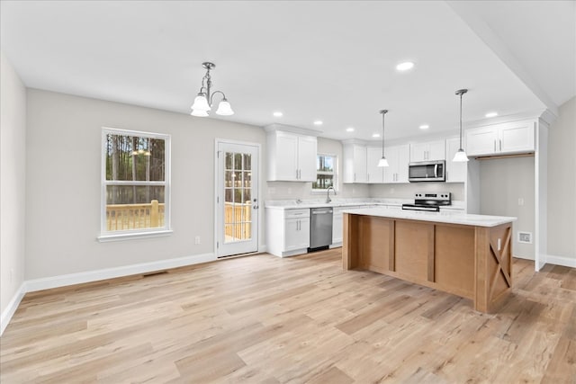 288 Flag Way, Chatsworth, GA 30705 - kitchen featuring white cabinets, light countertops, appliances with stainless steel finishes, and light wood-style flooring