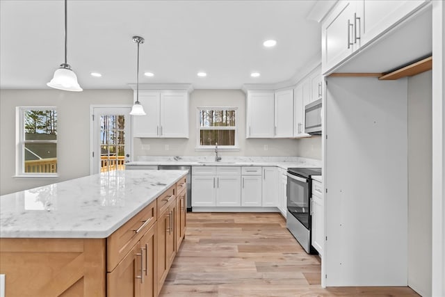 288 Flag Way, Chatsworth, GA 30705 - kitchen with a sink, a center island, stainless steel appliances, white cabinets, and light wood-style floors