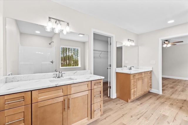 288 Flag Way, Chatsworth, GA 30705 - bathroom with a shower, a sink, two vanities, and wood finished floors