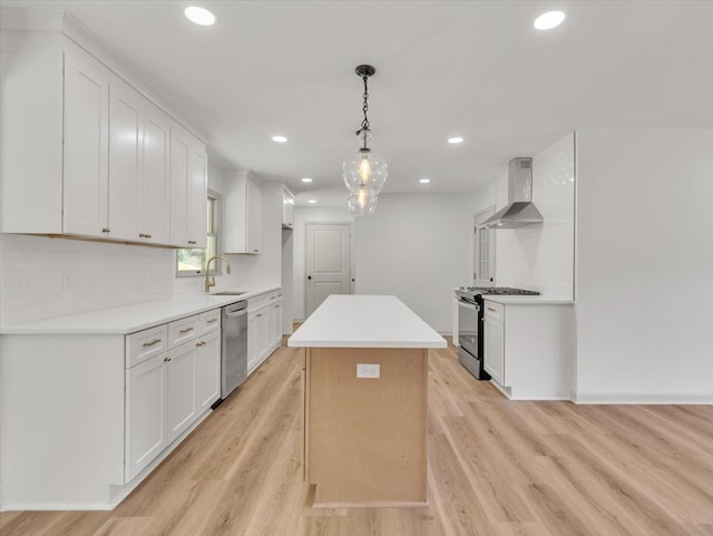 100 Tibbs Rd, Dalton, GA 30720 - kitchen featuring stainless steel appliances, wall chimney exhaust hood, white cabinets, recessed lighting, and light wood-type flooring