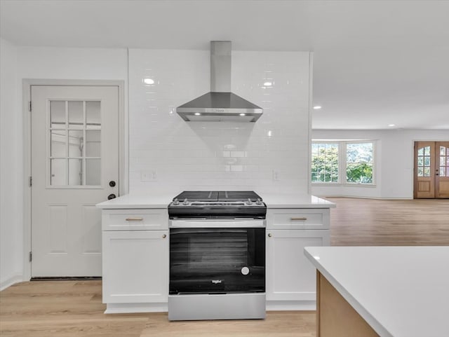 100 Tibbs Rd, Dalton, GA 30720 - kitchen featuring stainless steel gas range, wall chimney exhaust hood, white cabinets, light wood finished floors, and recessed lighting