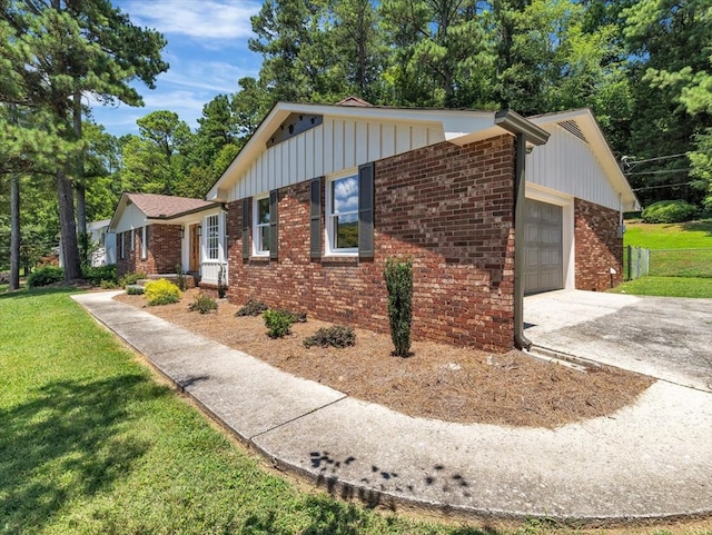 100 Tibbs Rd, Dalton, GA 30720 - view of side of property featuring brick siding, an attached garage, a yard, and driveway