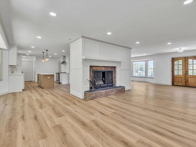 100 Tibbs Rd, Dalton, GA 30720 - unfurnished living room with light wood finished floors, recessed lighting, and a brick fireplace