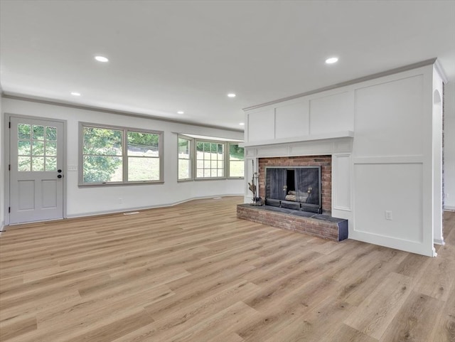 100 Tibbs Rd, Dalton, GA 30720 - unfurnished living room with light wood finished floors, healthy amount of natural light, a brick fireplace, and recessed lighting