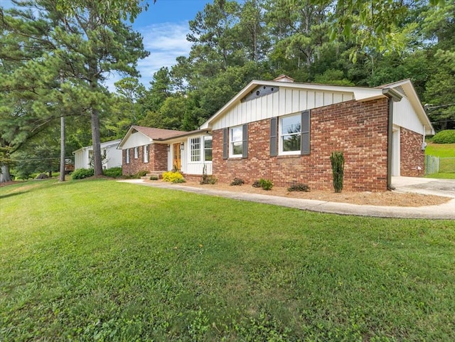 100 Tibbs Rd, Dalton, GA 30720 - ranch-style house with a garage, a front yard, brick siding, concrete driveway, and board and batten siding