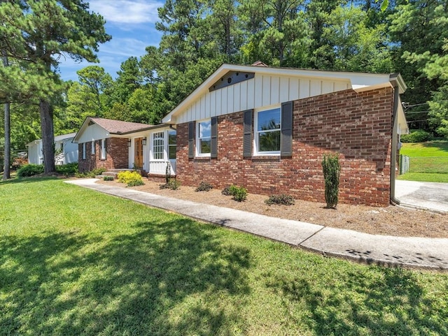 100 Tibbs Rd, Dalton, GA 30720 - single story home with board and batten siding, brick siding, and a front lawn