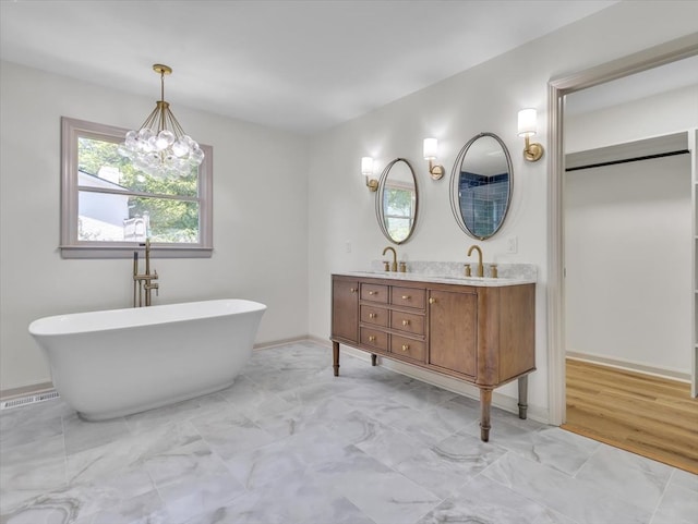 100 Tibbs Rd, Dalton, GA 30720 - full bath featuring double vanity, a freestanding tub, marble finish flooring, and a chandelier
