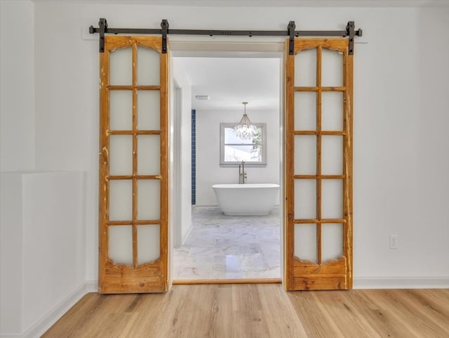 100 Tibbs Rd, Dalton, GA 30720 - empty room featuring a barn door and wood finished floors