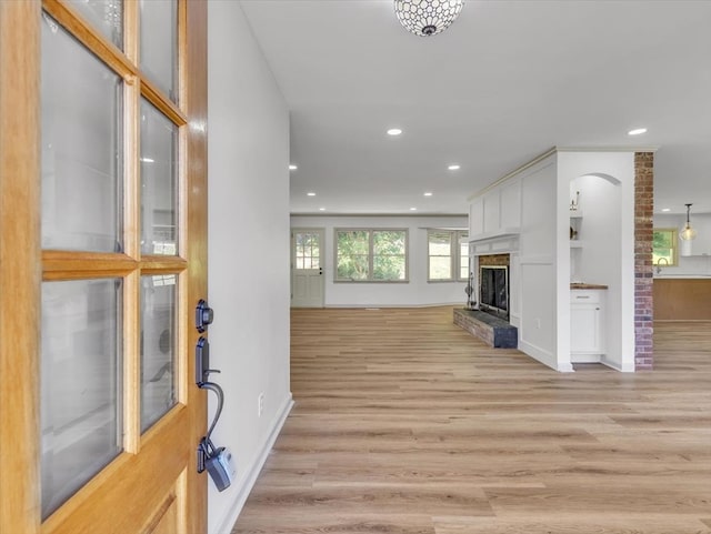 100 Tibbs Rd, Dalton, GA 30720 - unfurnished living room with light wood-style flooring, recessed lighting, arched walkways, and a fireplace with raised hearth