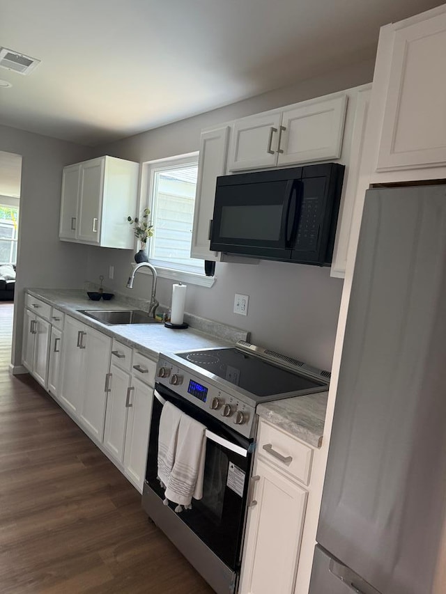 303 Janice St, Dalton, GA 30721 - kitchen with appliances with stainless steel finishes, white cabinetry, and healthy amount of natural light