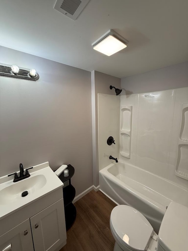 303 Janice St, Dalton, GA 30721 - full bath featuring wood finished floors, vanity, and washtub / shower combination