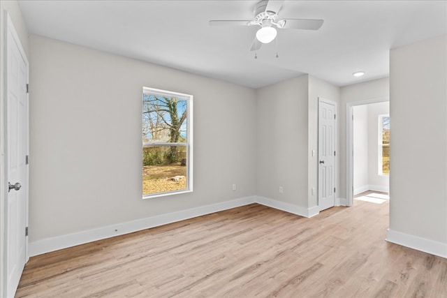 unfurnished bedroom featuring light wood finished floors, ceiling fan, and baseboards