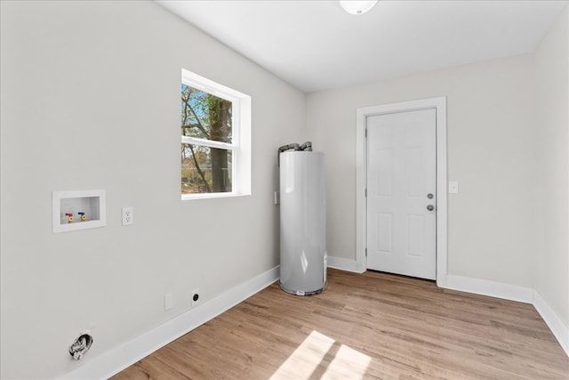 laundry area with hookup for a washing machine, laundry area, baseboards, water heater, and light wood-style floors