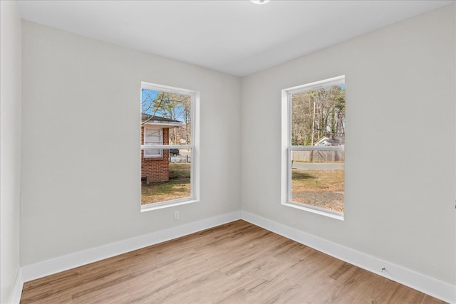 empty room featuring baseboards and wood finished floors