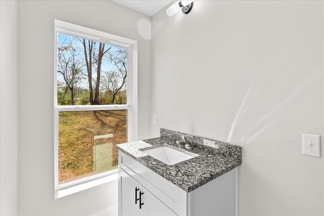 bathroom featuring a healthy amount of sunlight and vanity