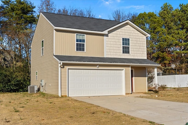 view of front facade with cooling unit, a garage, and a front lawn