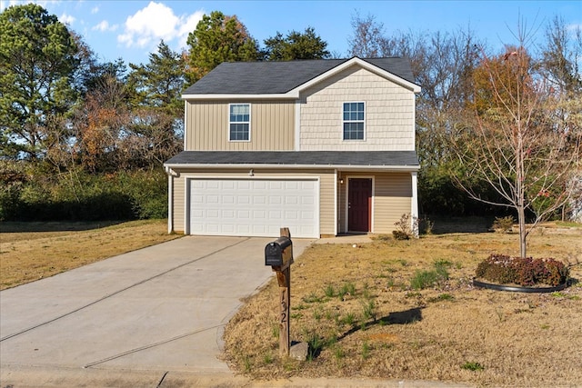 view of front of home with a garage and a front yard