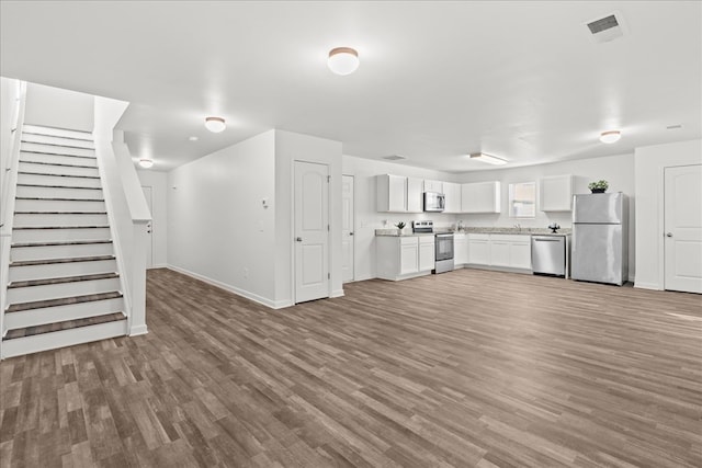 kitchen featuring white cabinetry, hardwood / wood-style floors, and stainless steel appliances