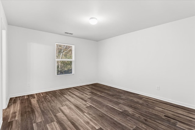 spare room with dark hardwood / wood-style flooring