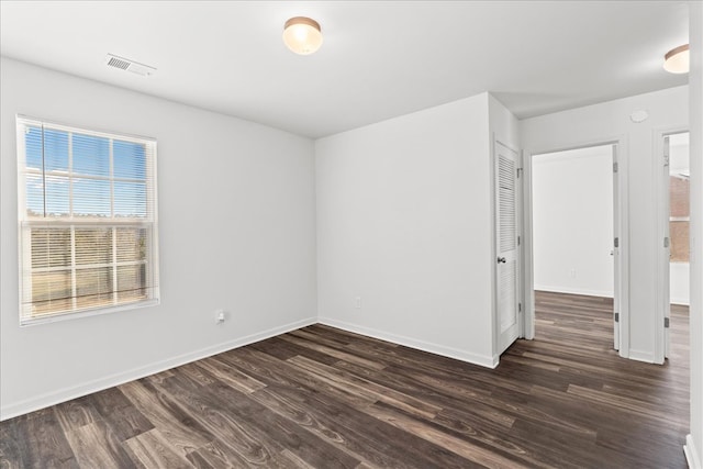 spare room with dark hardwood / wood-style flooring