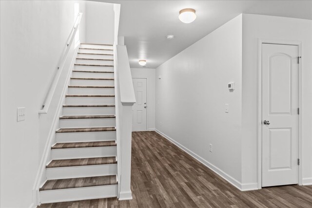 stairs with hardwood / wood-style floors