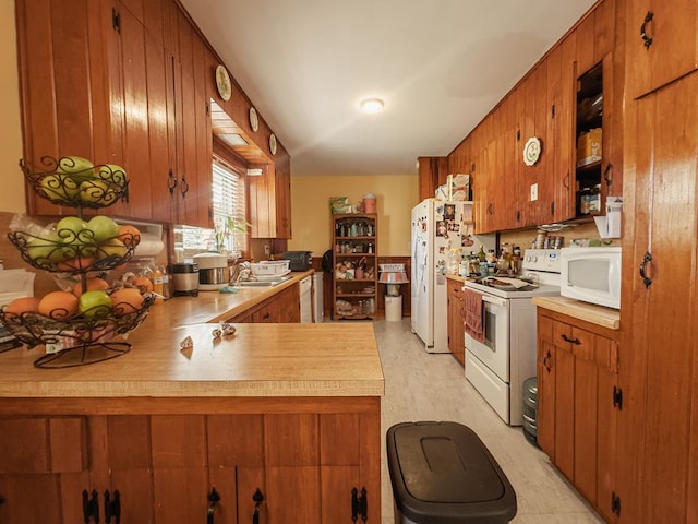 209 Kenemer Cir, Dalton, GA 30720 - kitchen featuring white appliances, brown cabinetry, light countertops, and a sink