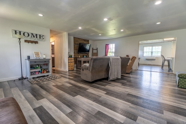 living area featuring recessed lighting, baseboards, and dark wood-style flooring