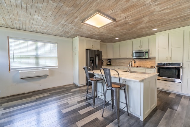 kitchen featuring appliances with stainless steel finishes, wood ceiling, a kitchen bar, tasteful backsplash, and dark wood-style flooring