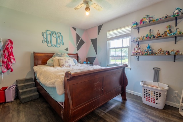bedroom featuring wood finished floors, a ceiling fan, and baseboards
