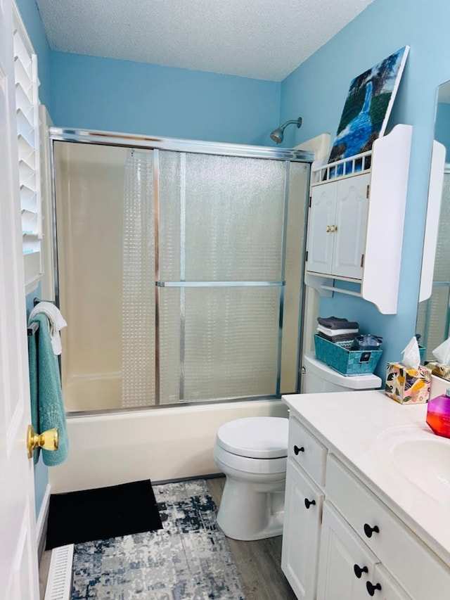4511 Crestway Dr, Cohutta, GA 30710 - full bath with vanity, wood finished floors, bath / shower combo with glass door, and a textured ceiling