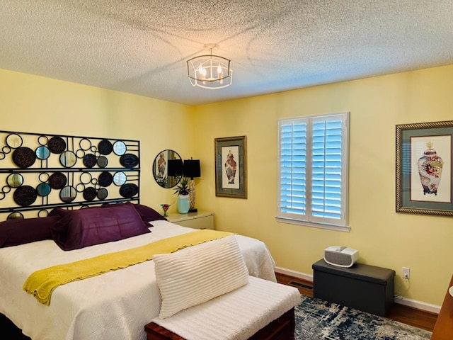 4511 Crestway Dr, Cohutta, GA 30710 - bedroom featuring a chandelier, wood finished floors, and a textured ceiling