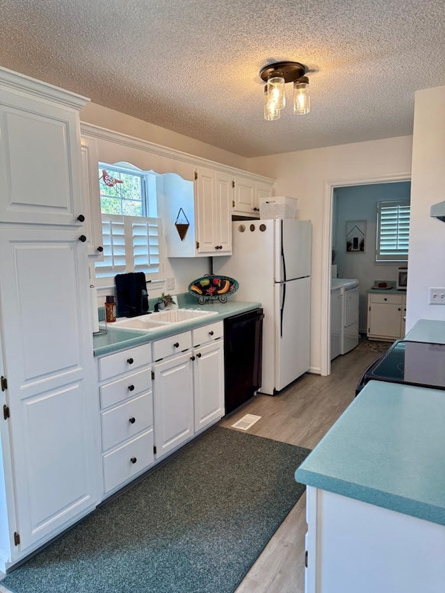 4511 Crestway Dr, Cohutta, GA 30710 - kitchen with dishwasher, washer and dryer, light wood finished floors, a textured ceiling, and white cabinets