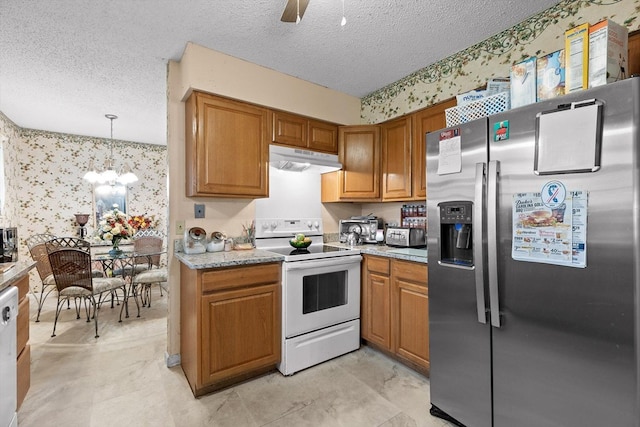 kitchen with a textured ceiling, under cabinet range hood, white appliances, and wallpapered walls