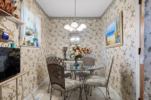 dining space featuring baseboards, a chandelier, and wallpapered walls
