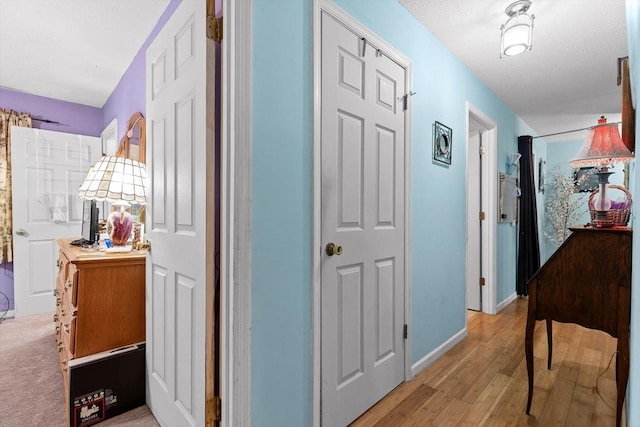 corridor with light wood-style floors