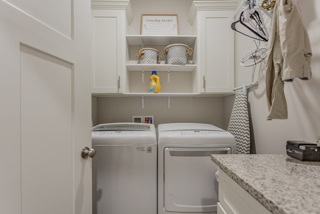 laundry room featuring cabinet space and washer and clothes dryer