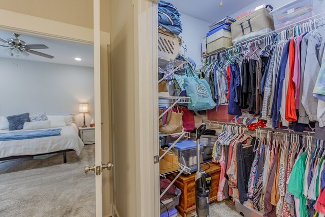 walk in closet with ceiling fan