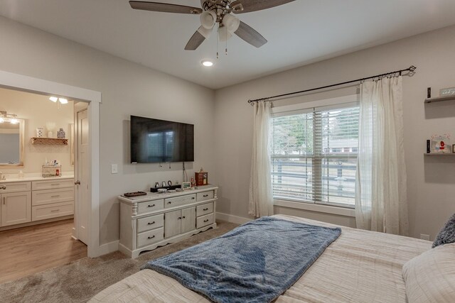 bedroom featuring baseboards, a ceiling fan, recessed lighting, ensuite bath, and light colored carpet