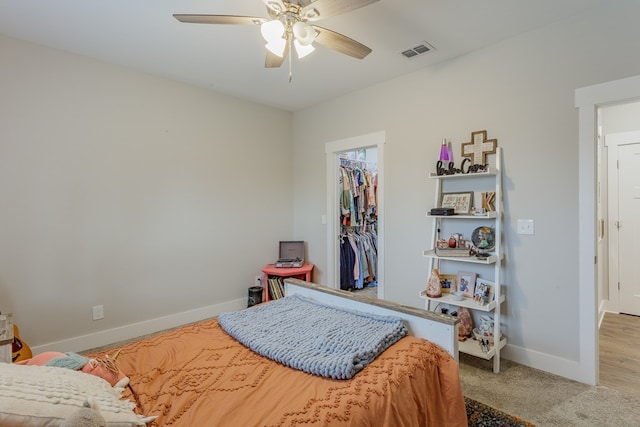 bedroom with visible vents, baseboards, a closet, a spacious closet, and carpet floors