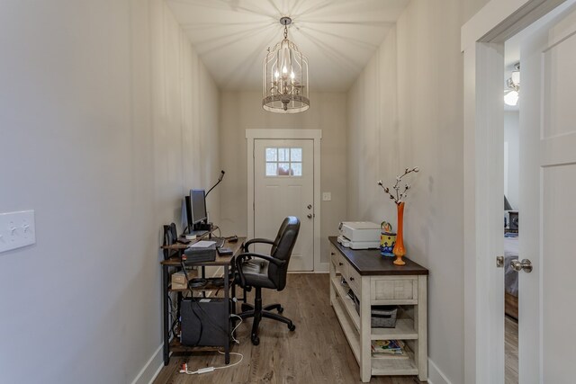 office featuring a notable chandelier, baseboards, and wood finished floors