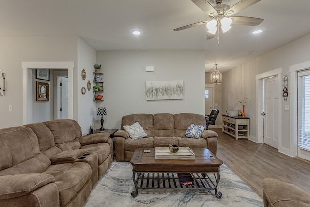living room with wood finished floors, ceiling fan, baseboards, and recessed lighting